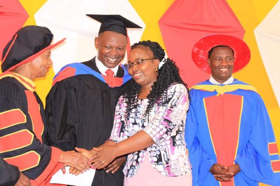 Graduation ceremony handshake with academic staff